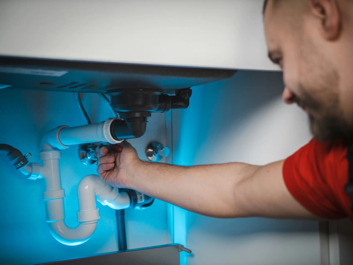 Plumber fixing a pipe